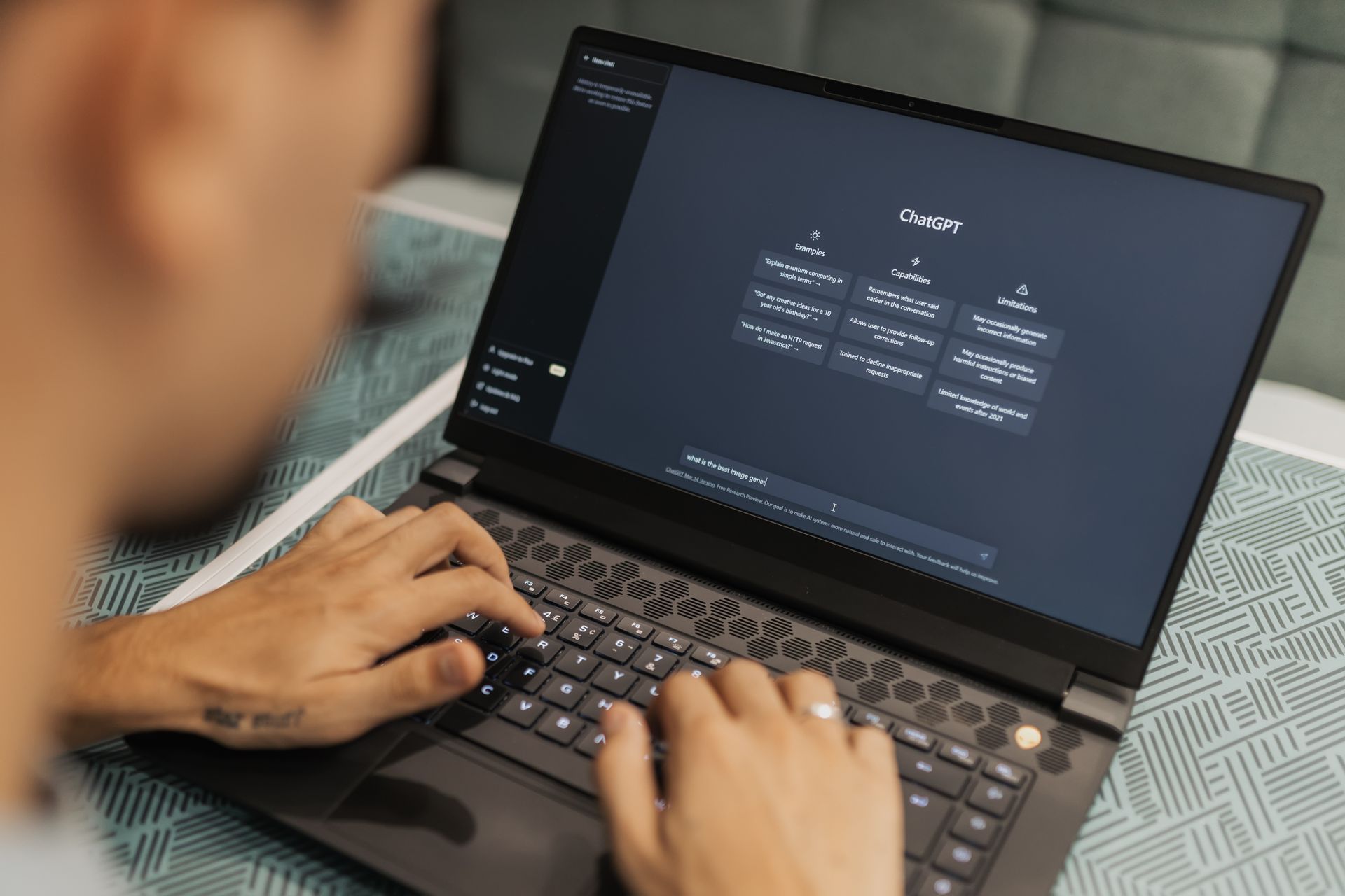 Marketer using ChatGPT on a laptop to generate conversion optimisation hypotheses