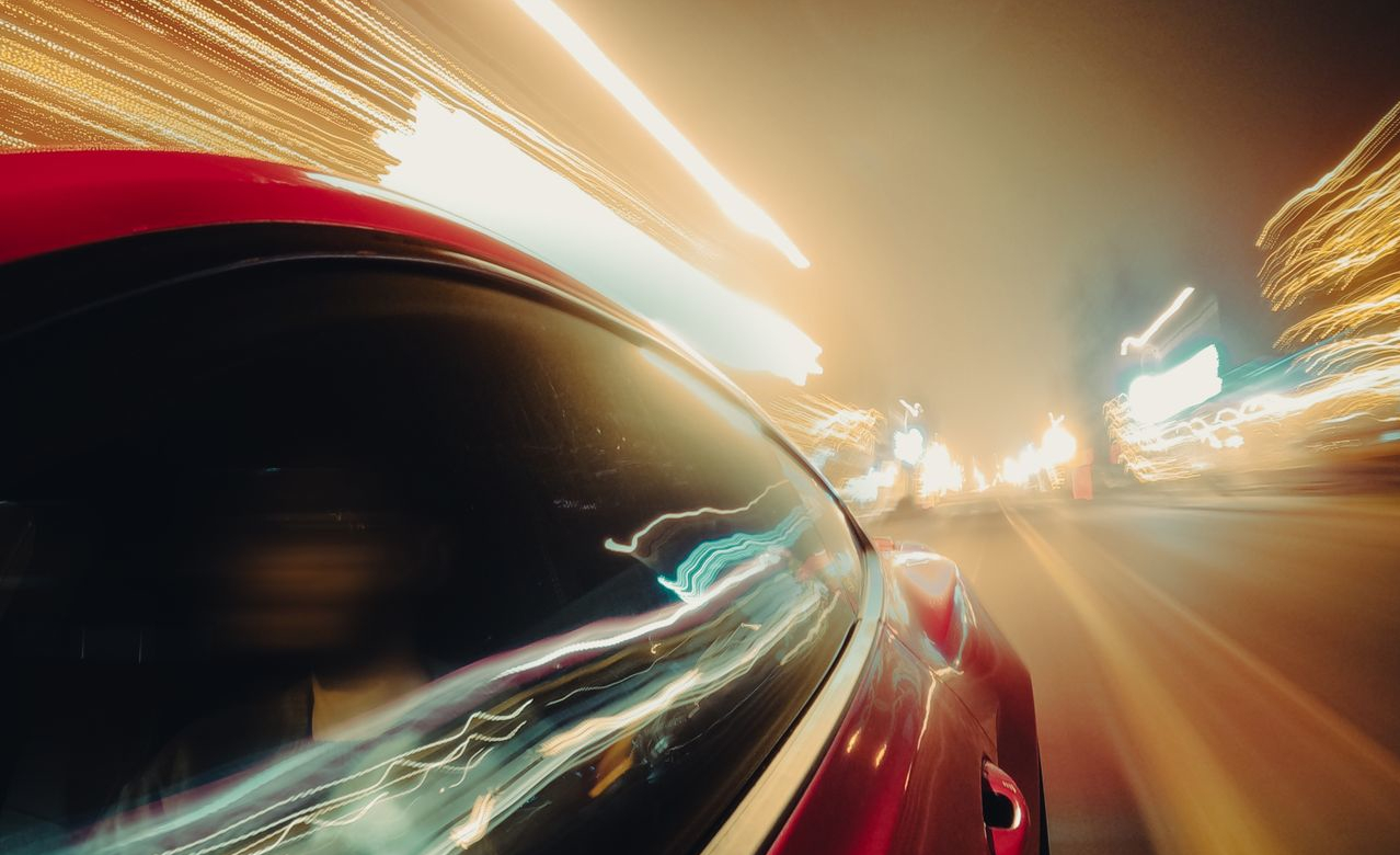 Car speeding through city lights — page load speed and conversion rate